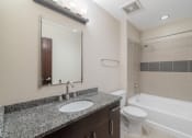 Thumbnail 13 of 36 - a bathroom with a sink and a toilet and a bath tub