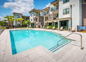 Thumbnail 12 of 26 - Centre Pointe Apartments resort-style pool area with surrounding sundeck