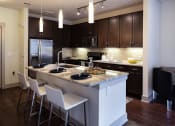 Thumbnail 12 of 19 - The Juncture Apartments brown kitchen cabinets
