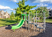 Thumbnail 11 of 31 - Playgrounds with green slide - Lantern Woods Apartments
