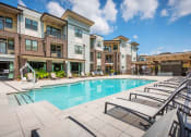 Thumbnail 13 of 26 - Centre Pointe Apartments resort-style pool area with surrounding sundeck