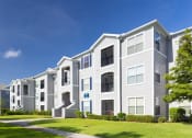 Thumbnail 12 of 24 - Courtney Station Apartments - Building exterior with manicured lawn