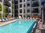 Thumbnail 13 of 24 - Swimming pool with lounge chairs - Rockwell at Crown