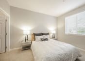 Thumbnail 13 of 17 - a bedroom with a bed and a large window