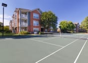 Thumbnail 14 of 24 - Belle Harbour Apartments outdoor lighted tennis court