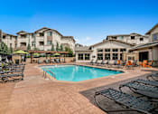 Thumbnail 15 of 29 - Resort-style swimming pool surrounded by lounge chairs - First and Main Apartments