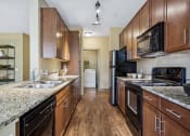 Thumbnail 16 of 22 - Black appliances in kitchens  - Acadia at Cornerstar Apartments