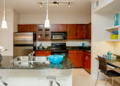 Thumbnail 17 of 24 - 3000 Sage - Gourmet kitchen with modern fixtures and nearby built-in desk