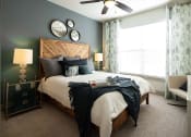 Thumbnail 17 of 19 - The Juncture Apartments bedroom with ceiling fans