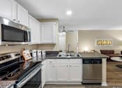 Thumbnail 19 of 25 - Modern kitchen with white cabinets - The Colony at Deerwood Apartments
