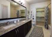 Thumbnail 18 of 19 - The Juncture Apartments bathroom with double vanity and linen closet