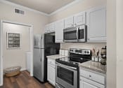 Thumbnail 17 of 30 - a kitchen with stainless steel appliances and white cabinets