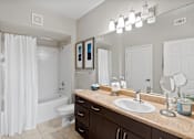 Thumbnail 19 of 22 - A bathroom with a white shower curtain and a white toilet.