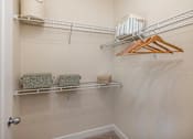 Thumbnail 20 of 22 - A white closet with a towel and a hanger.
