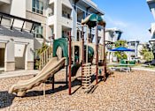 Thumbnail 19 of 32 - A playground with a slide and a climbing frame.