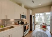 Thumbnail 20 of 22 - Large white cabinetry in kitchens in select units - BLVD at Revere Beach