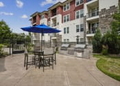 Thumbnail 20 of 36 - BBQ grilling station with picnic tables - Enclave at Cherry Creek