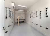 Thumbnail 20 of 32 - A white room with black handles on the wall.