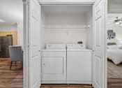 Thumbnail 21 of 30 - A white washer and dryer in a small room.