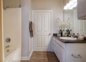 Thumbnail 22 of 24 - Island Park and Harbor Town Square Apartments - Wood-style flooring in bathrooms