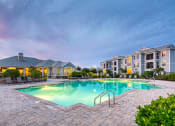 Thumbnail 24 of 24 - Courtney Station Apartments - Resort-style pool at dusk