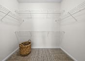 Thumbnail 25 of 30 - A room with white walls and a wicker basket on the floor.