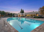 Thumbnail 25 of 25 - Lighted resort-style swimming pool at dusk