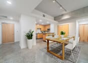 Thumbnail 26 of 42 - A modern kitchen with a dining table and chairs.