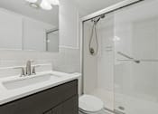 Thumbnail 28 of 28 - A white sink with a silver faucet is on a countertop in a bathroom.