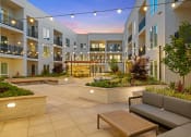 Thumbnail 30 of 32 - Courtyard with ample seating and romantic lighting - La Via Apartments