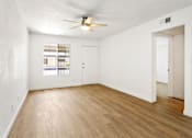 Thumbnail 7 of 29 - A room with a ceiling fan and a window with blinds.