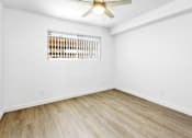 Thumbnail 11 of 29 - A room with a ceiling fan and a window with blinds.