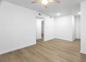 Thumbnail 14 of 29 - an empty living room with white walls and a ceiling fan