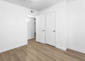 Thumbnail 15 of 29 - an empty room with white walls and white doors