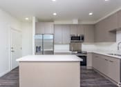 Thumbnail 20 of 25 - A kitchen with a white countertop and brown cabinets. at Plisko Place, Port Orchard, WA, 98366