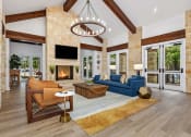 Thumbnail 7 of 30 - clubhouse lounge area with couches and a fireplace