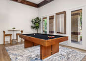 Thumbnail 6 of 30 - a billiards table in a living room with a pool table