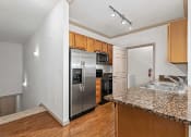 Thumbnail 21 of 30 - kitchen with access to stairs leading to the garage