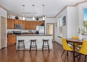 Thumbnail 27 of 30 - an open kitchen and dining room with a bar and stools