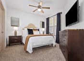 Thumbnail 24 of 30 - a bedroom with a bed and a ceiling fan