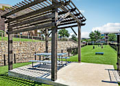 Thumbnail 18 of 64 - A wooden pergola is over a picnic table.