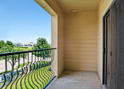 Thumbnail 62 of 64 - A balcony with a green railing and a view of the street below.
