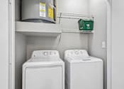 Thumbnail 46 of 64 - Two white front loading washing machines in a laundry room.