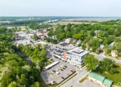 Thumbnail 2 of 15 - an aerial view of a city with cars in a parking lot