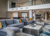Thumbnail 21 of 75 - two groups of gray couches around square coffee tables in an indoor atrium room at The Apex at CityPlace, Kansas