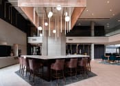 Thumbnail 54 of 75 - large indoor bar with 7 barstools seated around the countertop at The Apex at CityPlace, Overland Park, Kansas
