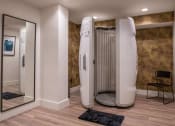 Thumbnail 29 of 75 - Prosun tanning bed in a room with a chair and full length mirror at The Apex at CityPlace, Overland Park, KS