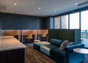 Thumbnail 48 of 75 - large couch in front of a wall mounted tv with chairs and desks behind it at The Apex at CityPlace, Overland Park, KS, 66210