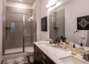 Thumbnail 36 of 75 - bathroom with a shower and double vanity at The Apex at CityPlace, Overland Park