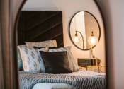 Thumbnail 38 of 75 - reflection of a bed and nightstand in a large mirror at The Apex at CityPlace, Overland Park, Kansas